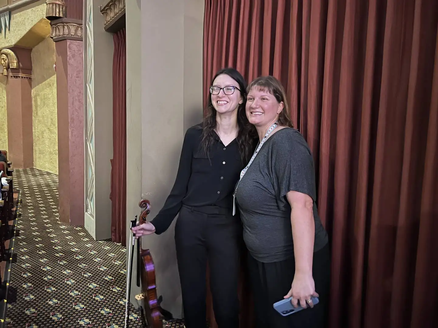 Kelsey Chelberg, the orchestra director at Huntley Middle School and a violinist in the Kishwaukee Symphony Orchesta, stands with Jill McCormick, the Founders Elementary School Music teacher and DeKalb Community School District 428's music coordinator on Nov. 15, 2024, before performing in front of about 1,000 school-aged children.