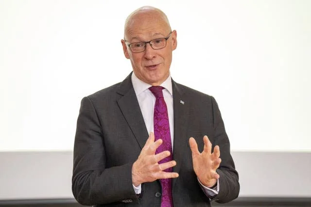 Head and shoulders photo of John Swinney speaking