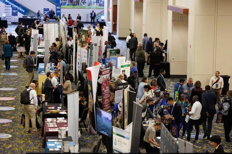 Speakers and attendees visit information booths at the World Food Prize Borlaug International Dialogue, in Des Moines, Iowa, on Oct. 29, 2024.