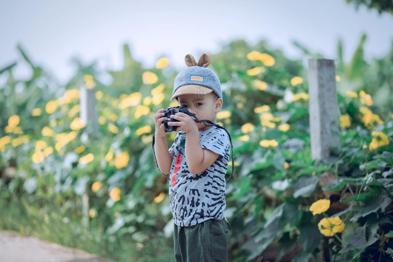 little boy outside with camera