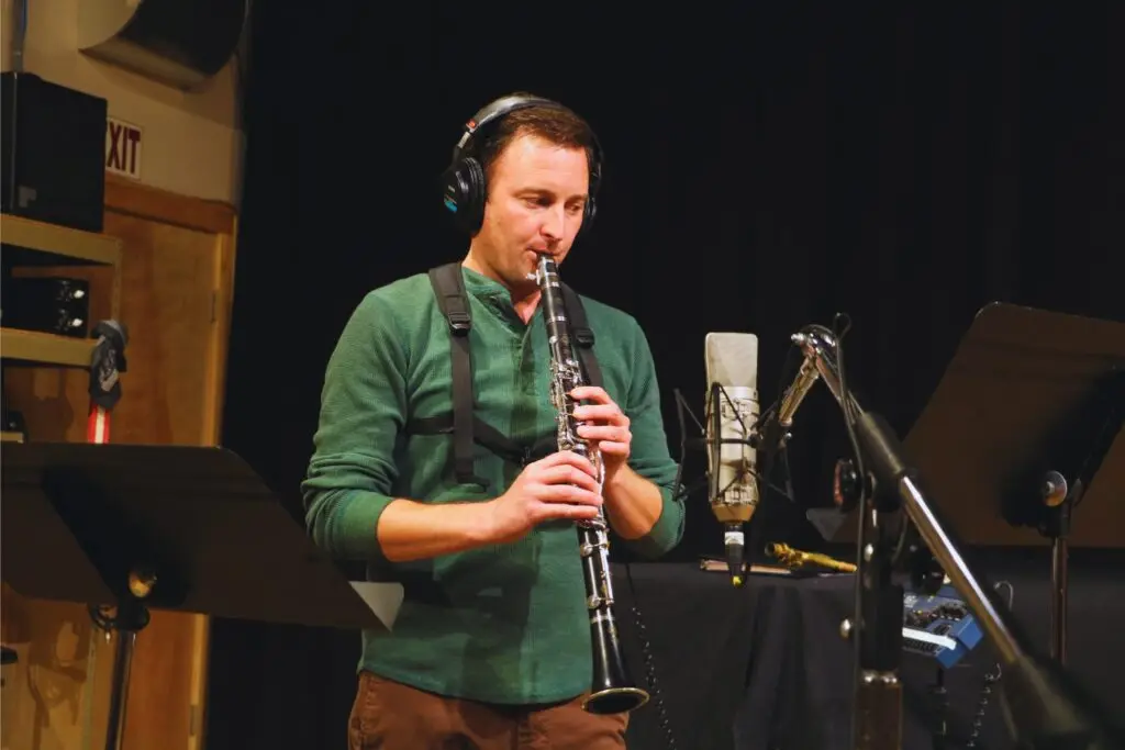 Denver musician Jacob Herold plays a clarinet into a microphone