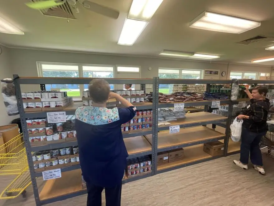 Staff at Hope Ministries stock the shelves at its food pantry. Executive director David Tidwell says the organization is reliant on volunteers.