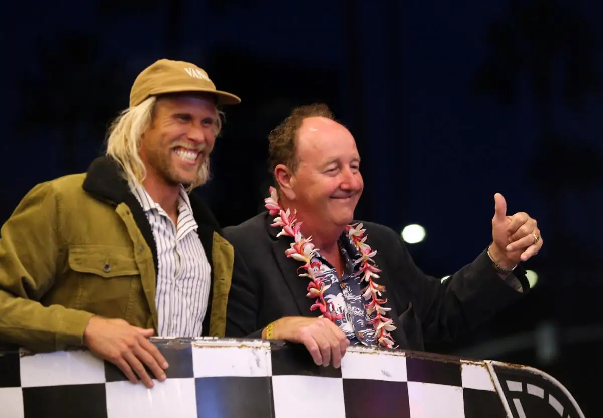 Steve Van Doren, center, poses with pro surfer Tanner Gudauskas at the Newport Beach Film Festival in 2021.