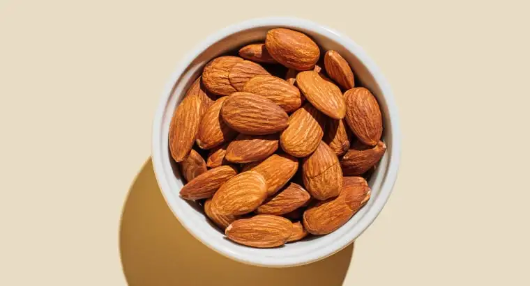 Almond nuts in white bowl 