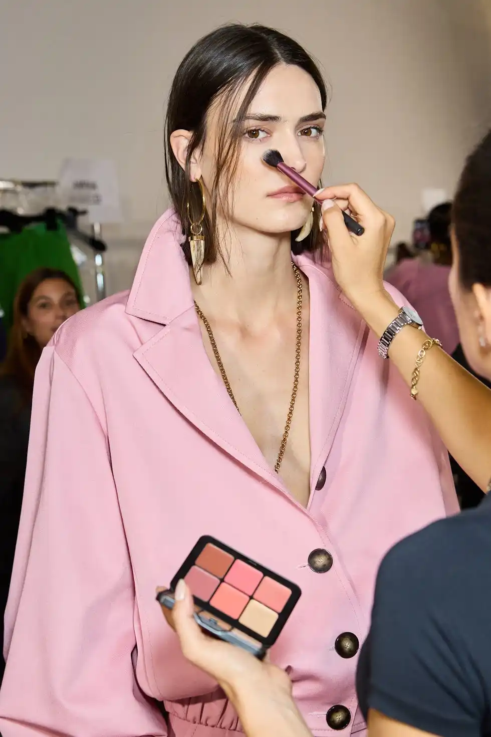 model receiving makeup application backstage