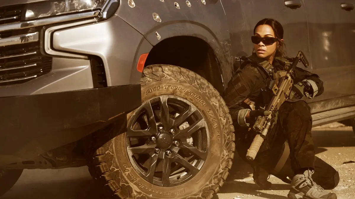 Zoe Saldana in Lioness holding a gun