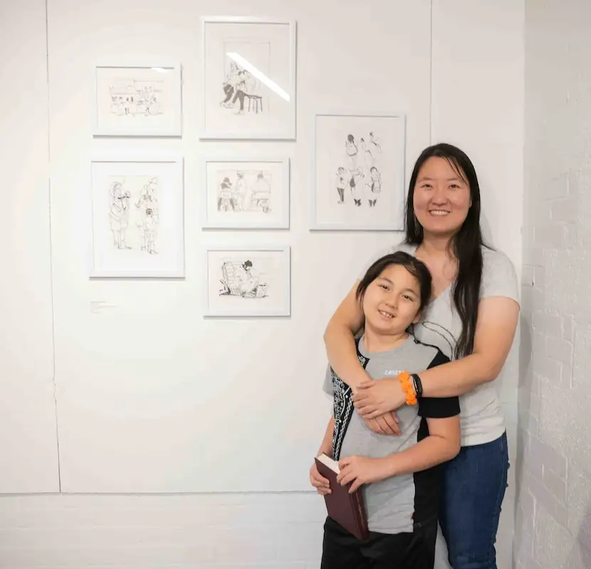 Dongjing Zhang Berglund poses with her son Gordon, 7, in front of her piece “People...