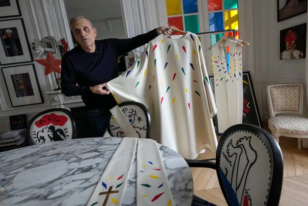 Jean-Charles de Castelbajac displays a liturgical vestment for priests to be worn at the reopening of the Notre Dame cathedral. He likens the shards of colour coming together on them to the cathedral’s rebirth. Photo: AP