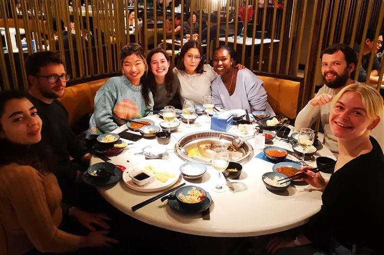 John Tregoning's lab group sit around a table at an end of year dinner.