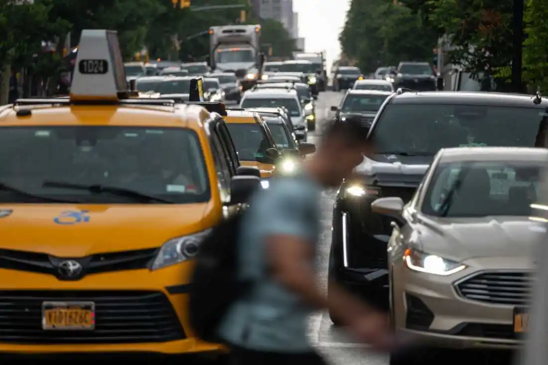 Pedestrians and cars move through midtown Manhattan traffic on June 6 in New York City. More than 94% of new vehicles in 2023 came with automatic emergency braking. And several other driver-assistance technologies are now standard in more than 90% of new cars, trucks and SUVs. 