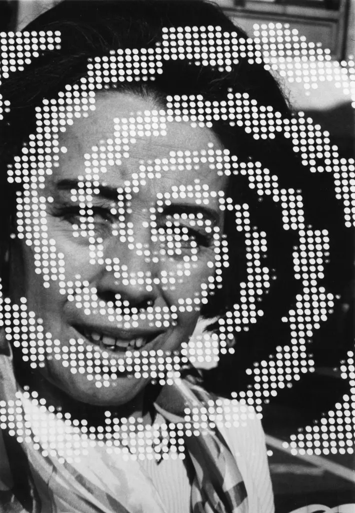 In this Barbara Crane photograph, a woman's face, mouth agape, can be seen behind a pixellated swirl shape. The image is in black and white.