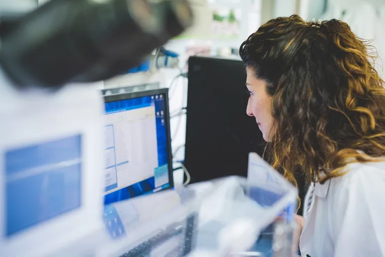 A researcher pictured using a FTIR spectrophotometer.