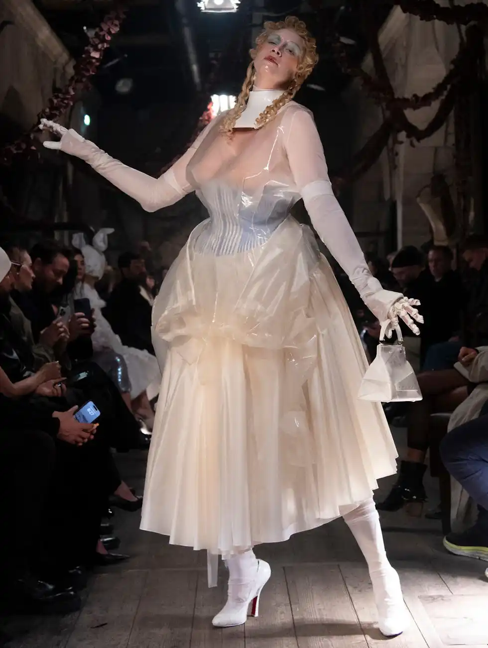 Fashion model showcasing a unique dress on a runway