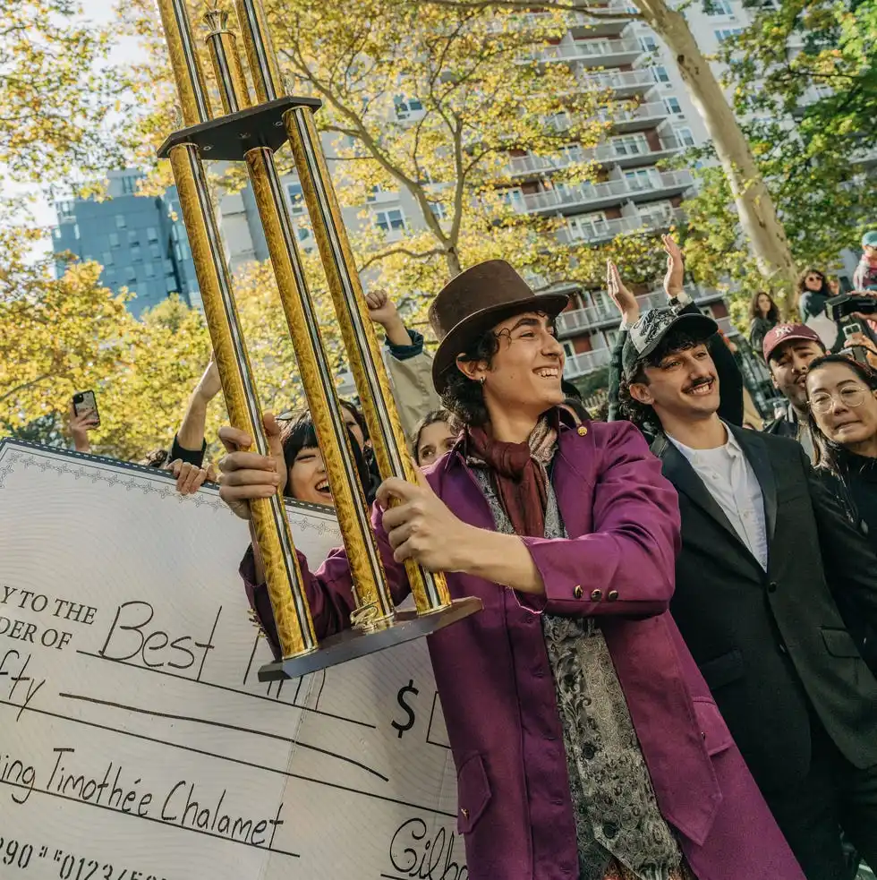 celebration with a large trophy and novelty check