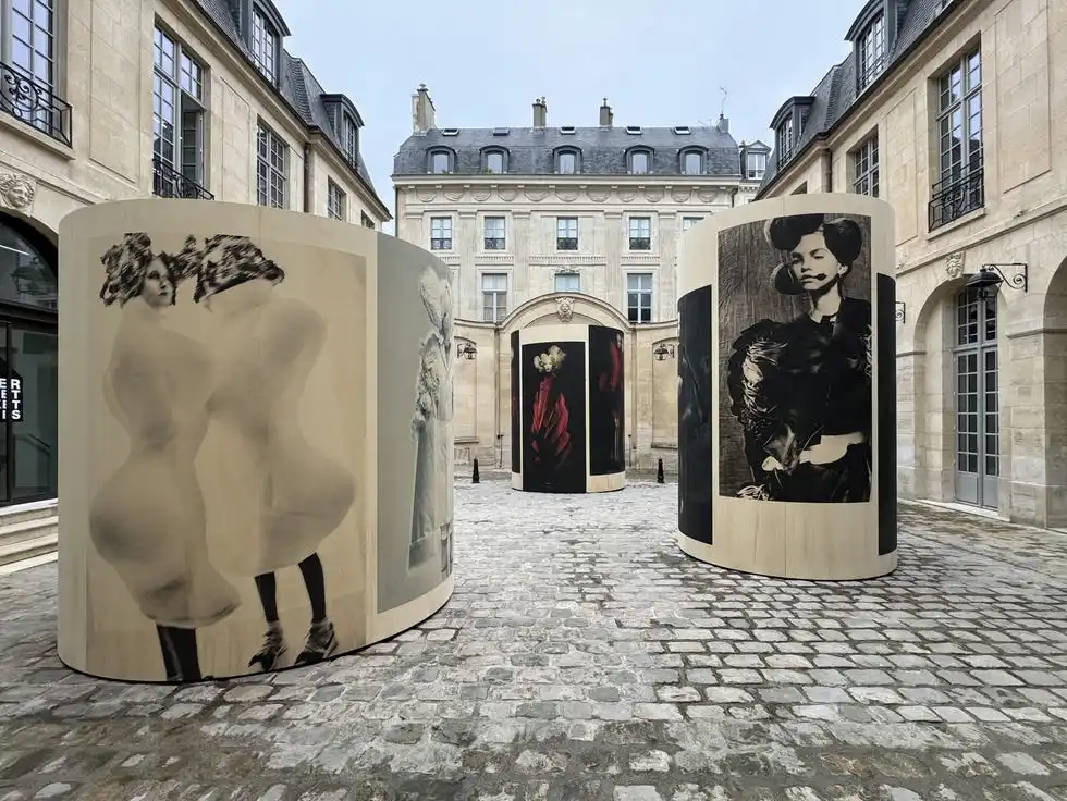 art installation featuring cylindrical displays with artistic images