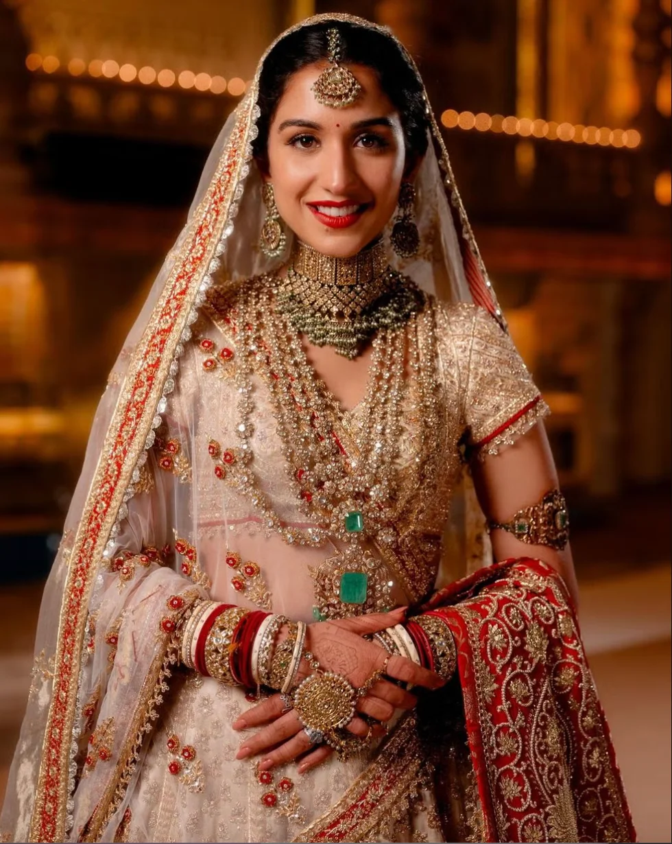 a bride in traditional attire adorned with intricate embellishments and jewelry