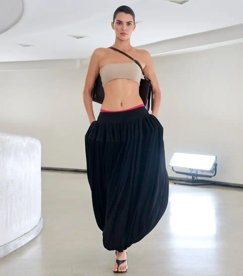 Model showcasing a fashion outfit in a modern interior