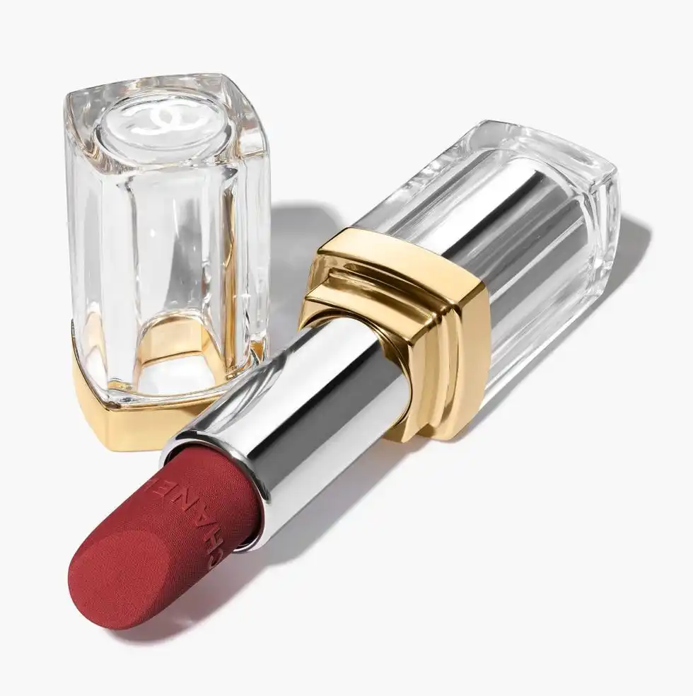 lipstick tube with a gold and clear design featuring a red lipstick bullet