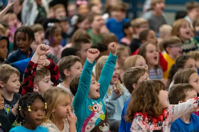 Kids cheer during the Pacers Sports & Entertainment 15th annual Big Toy Giveaway at Tekoppel Elementary School in Evansville, Ind., Thursday, Dec. 5, 2024.