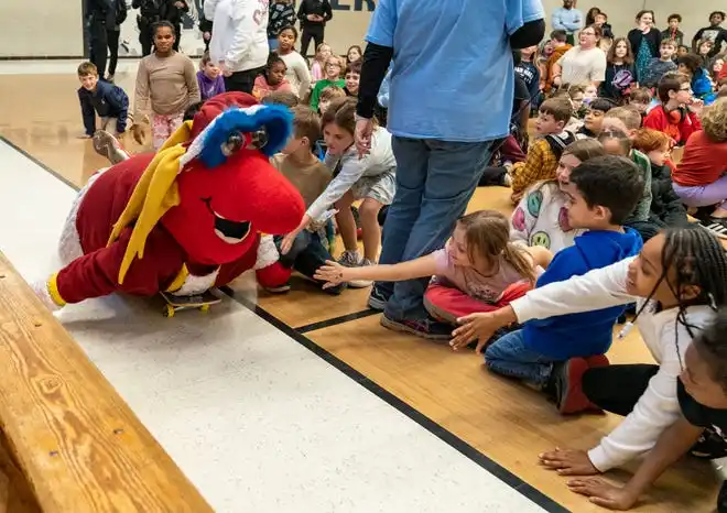 Indiana Fever mascot Freddy Fever glides on a skateboard during the Pacers Sports & Entertainment 15th annual Big Toy Giveaway at Tekoppel Elementary School in Evansville, Ind., Thursday, Dec. 5, 2024.