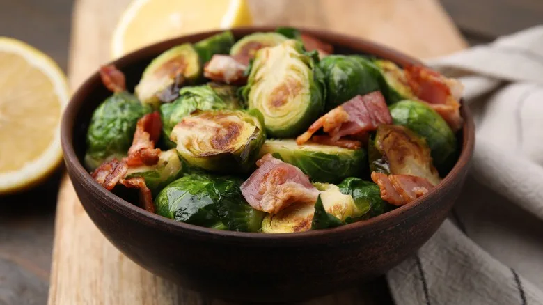 Brussels sprouts with bacon in a wooden bowl