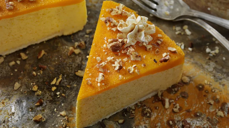 pumpkin cheesecake served with crumbled walnuts and icing