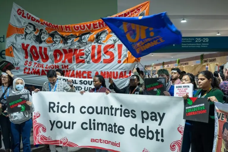 Activists protest at the COP29 venue, urging developed countries to acknowledge their role in the climate crisis. Image courtesy of COP29 Azerbaijan Presidency via flickr.