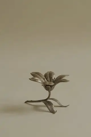 A metal ashtray in the shape of a flower