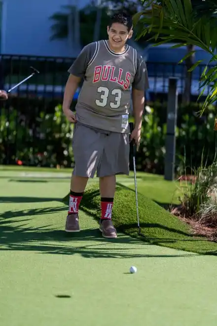 Jason Vasquez Jr., 11, watches his putt at PopStroke on December 20, 2024, in West Palm Beach, Florida. Tiger Woods, Greg Bartoliand TaylorMade Golf Company are the owners.