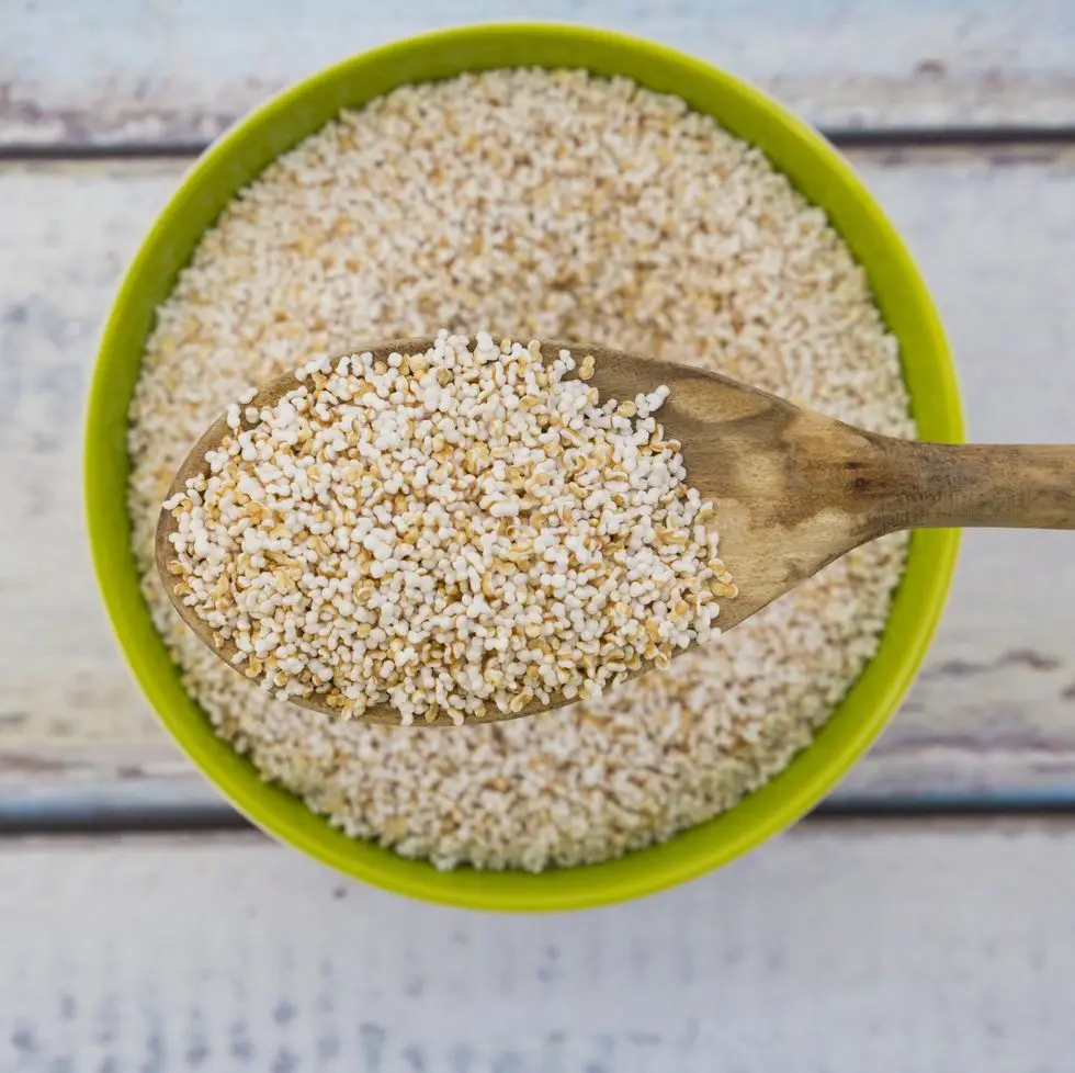 popped organic amarant on wood spoon and in bowl