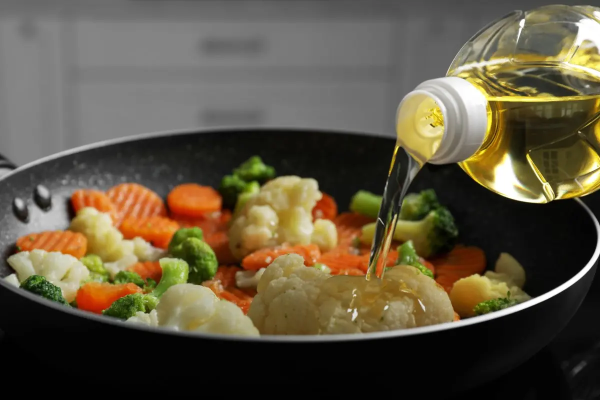 Pouring oil over vegetables