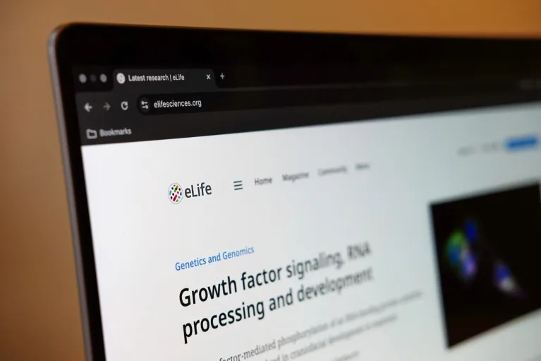 Close up of a laptop screen with the eLife journal homepage displayed