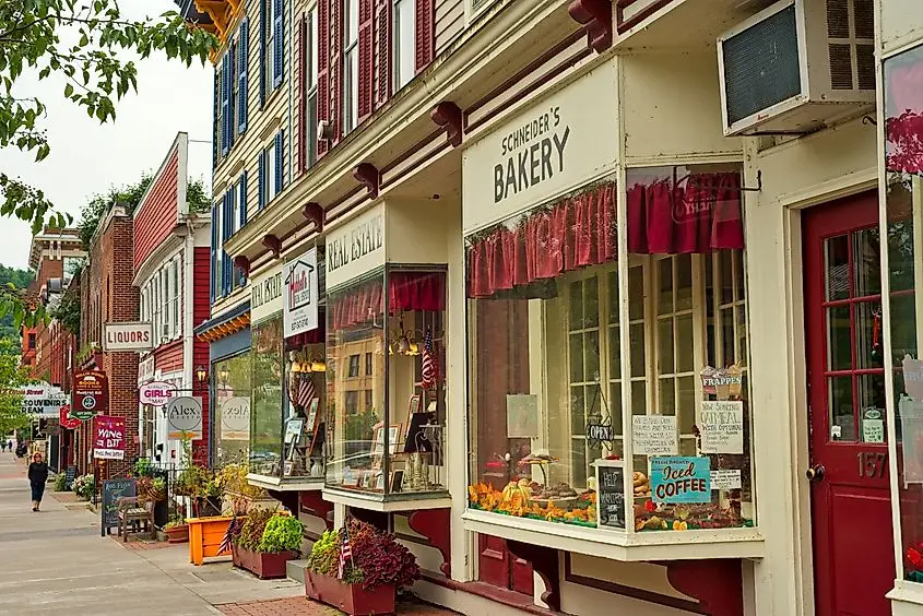 Shops, eateries, and baseball-themed attractions line the sidewalk on Main Street in Cooperstown, New York. Editorial credit: Kenneth Sponsler / Shutterstock.com