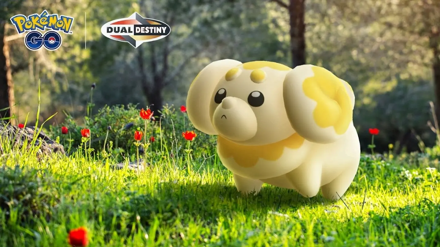 Text in the top left corner reads Pokémon GO Dual Destiny. A Fidough is shown walking on a grassy meadow with small red flowers, with trees shown out of focus in the background