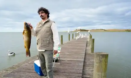 Tony Armstrong with a carp in Eat the Invaders, one of the invasive species in the show.