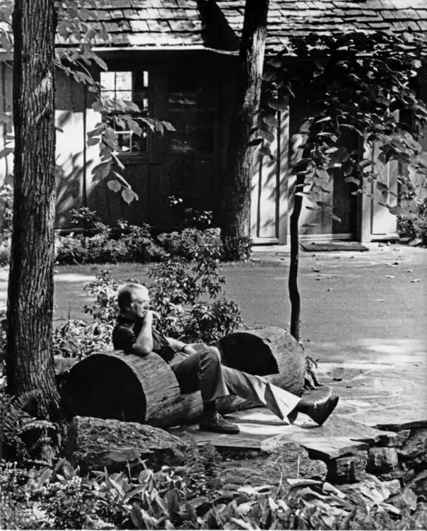 President Jimmy Carter sitting alone on a bench at Camp David