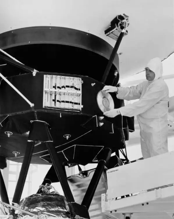 A technician puts the golden record on the Voyager spacecraft in a clean room before launch