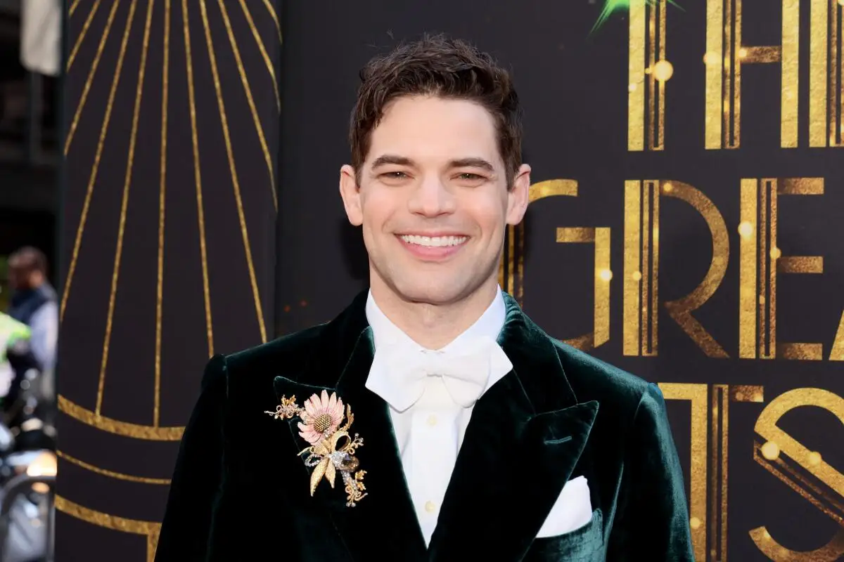 A man smiling in white tie 