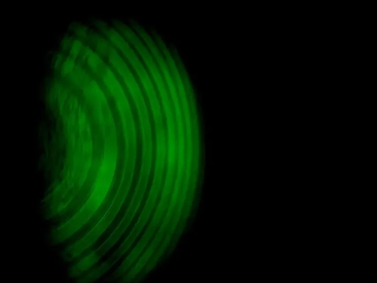 A concept image showing the Zeeman effect in green on a black background