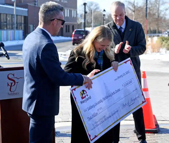 Jake Day, secretary of Housing & Community Development, hands Carolyn Ringer Lepre, Salisbury University president, a ceremonial check representing the $2 million in grant funding awarded for the proposed downtown Salisbury performing arts center Monday, Jan. 13, 2025, in Salisbury, Maryland.