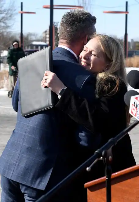 Jake Day, secretary of Housing & Community Development, hugs Carolyn Ringer Lepre, Salisbury University president, after the funding announcement Monday, Jan. 13, 2025, in Salisbury, Maryland.