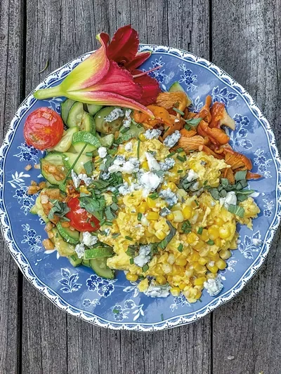 Scrambled eggs with foraged chanterelles and a daylily - SUZANNE PODHAIZER