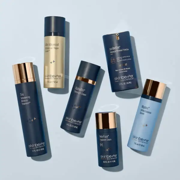 A collection of six expertly crafted skincare products in cylindrical bottles, featuring various sizes and colors, elegantly arranged on a light blue background.