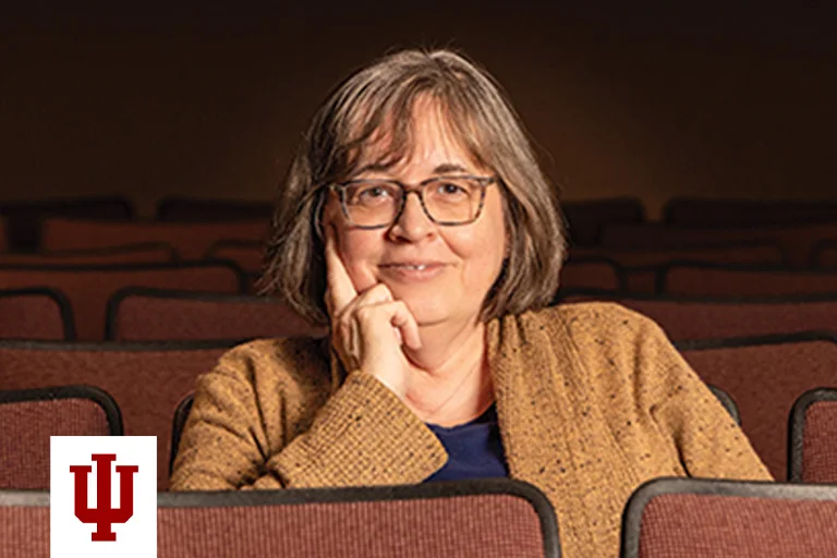 A portrait of a woman in a brown sweater