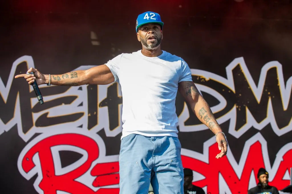 Method Man performing onstage at the 2024 ONE MusicFest in Central Park, Atlanta, Georgia with arms out in front.