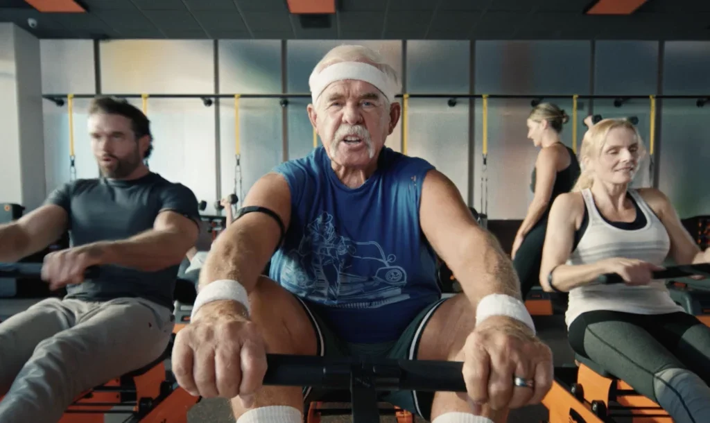 old man rides a rowing machine at Orangetheory Fitness