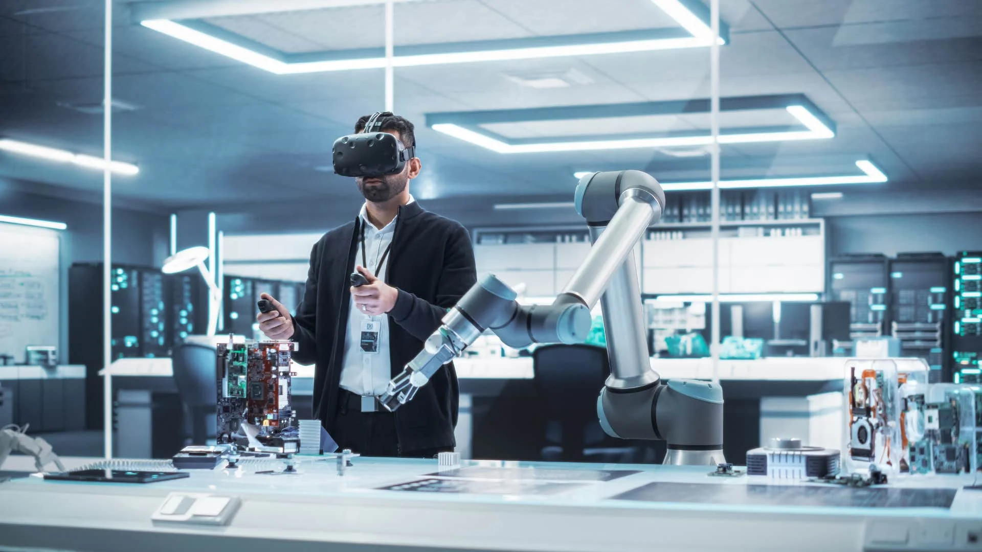 man working in a robotics lab wearing VR headset