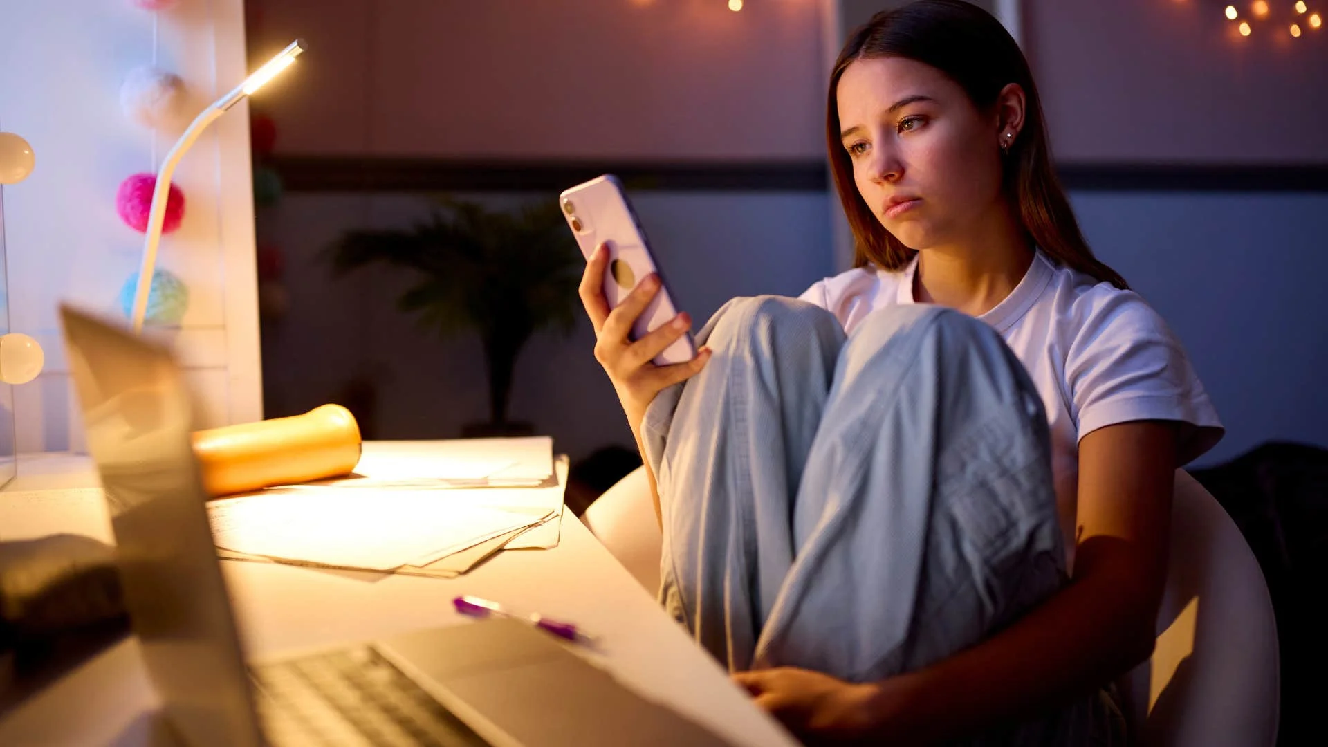 Lonely teen girl staring at phone