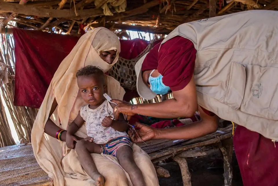 On Dec. 2, 2024, Abdulgader is screened for malnutrition by health volunteers during a UNICEF-supported door-to-door nutrition campaign in Aroma locality, Kassala state, Sudan.