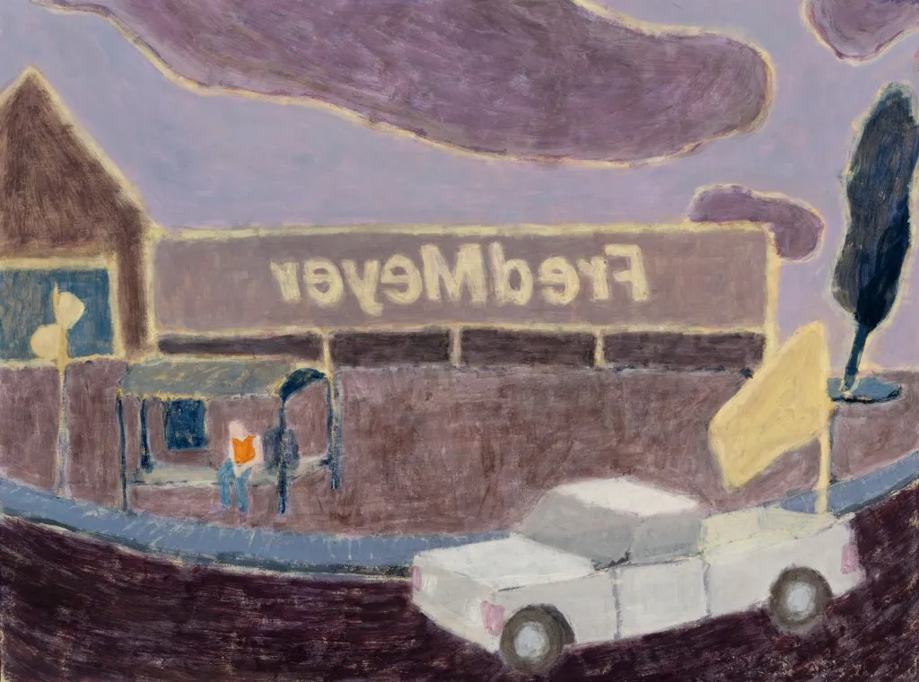 white pickup in front of a lavender storefront with Fred Meyer written in reverse